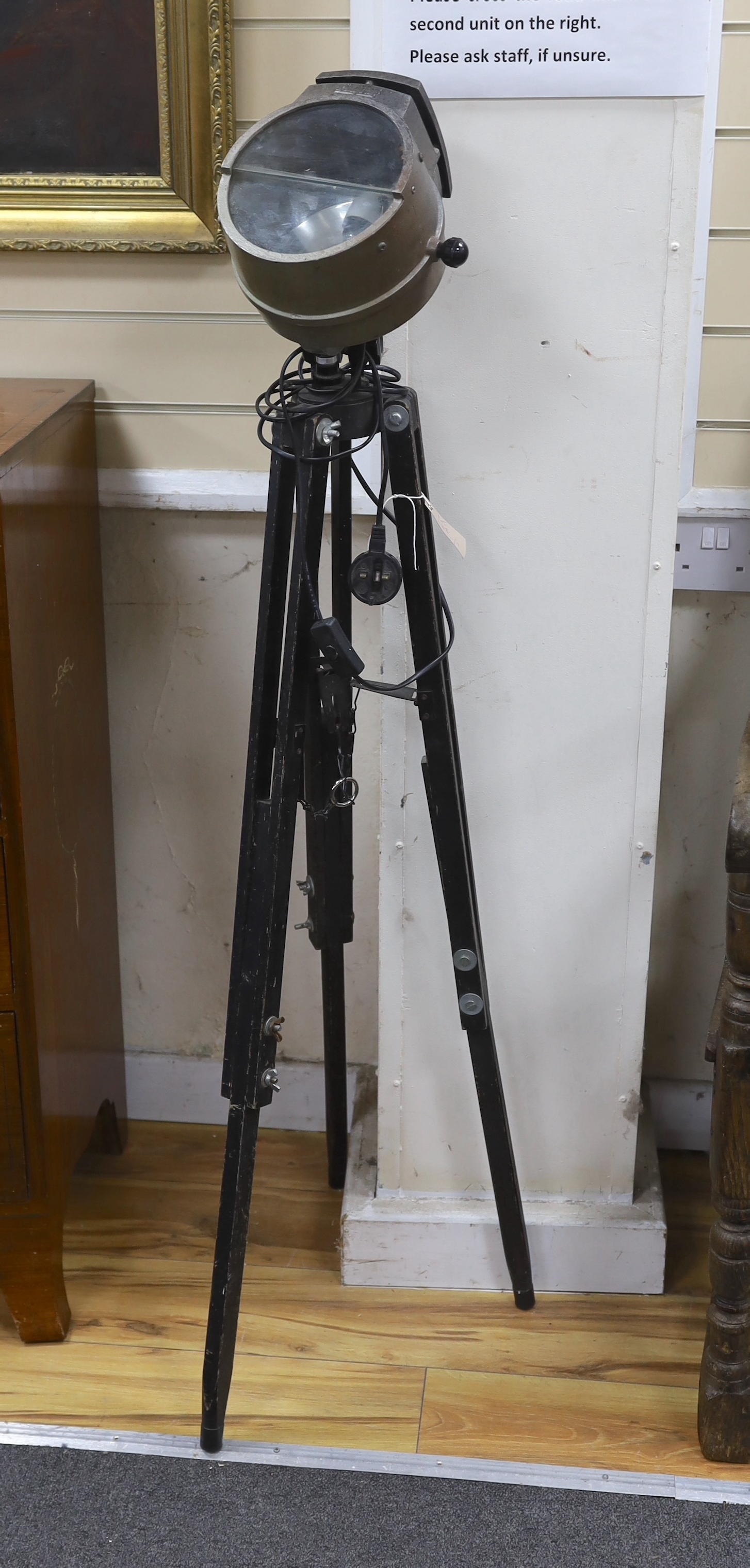 A Bulfinch film set flood lamp formerly gas-powered, on tripod stand